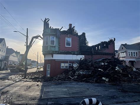 (WJAR) Firefighters began the process of demolishing a rooming house in New Bedford on Wednesday after a massive fire. . Rooming house fire new bedford